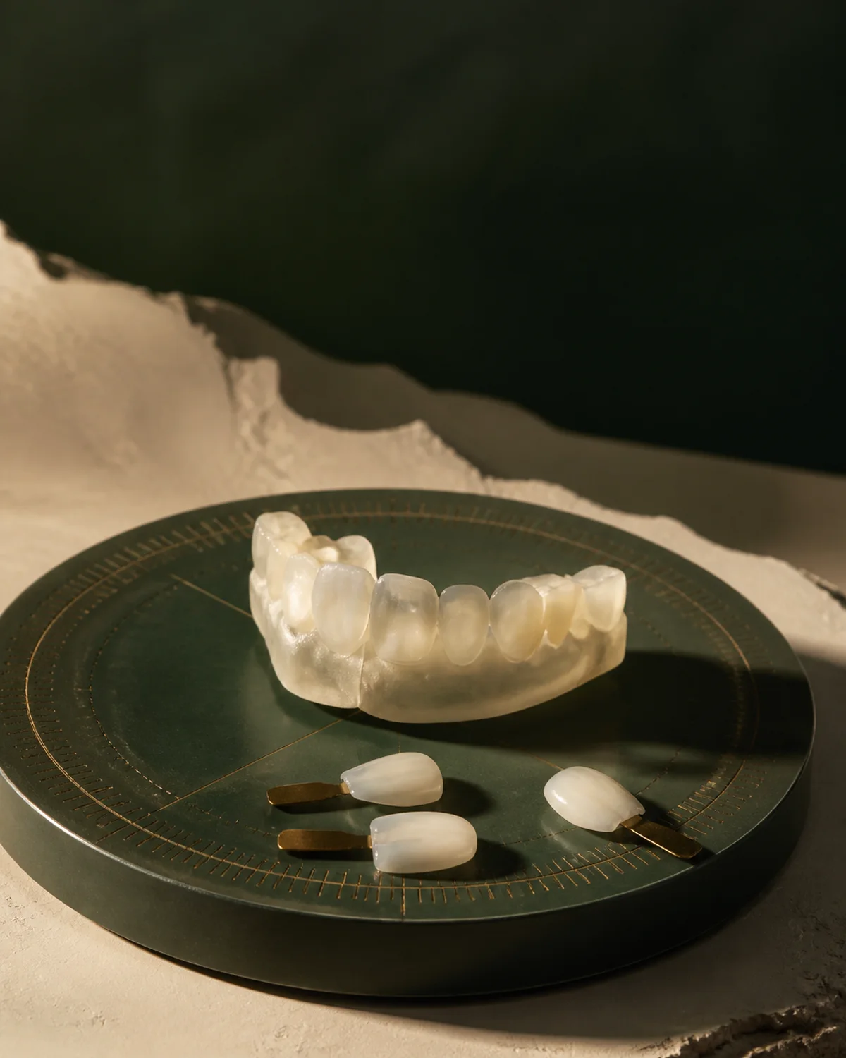 Generated ceramic dental study objects on a calibrated mineral-green examination plate